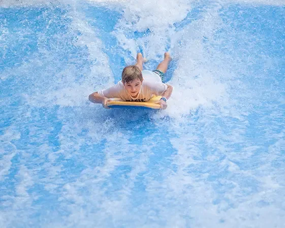 Rider on a sheet wave surf simulator